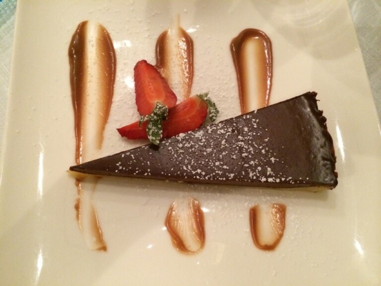 A chocolate tart served on a white plate from the Viking River Cruises menus.