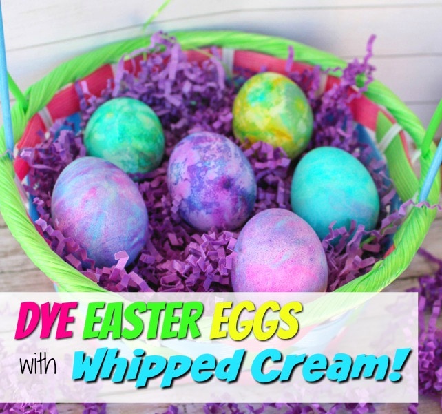 basket of colored marbled easter eggs on purple grass