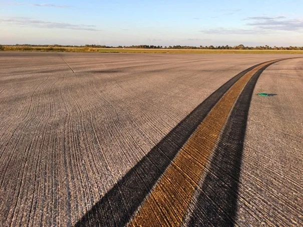 yellow and black lines on asphalt runway