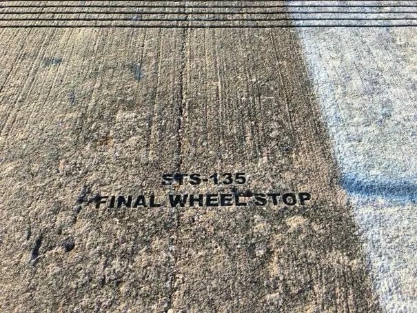 space shuttle runway with engraved words sts-135 final wheel stop