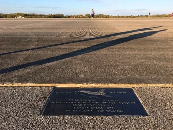 plaque on edge of runway with image of a space shuttle