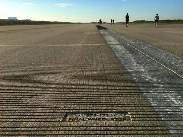 grooved pavement on a runway with a thick white stripe