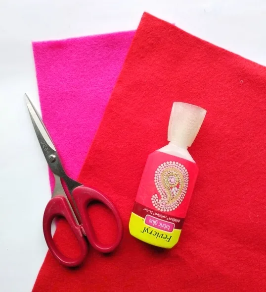 pink and red felt with scissors and glue