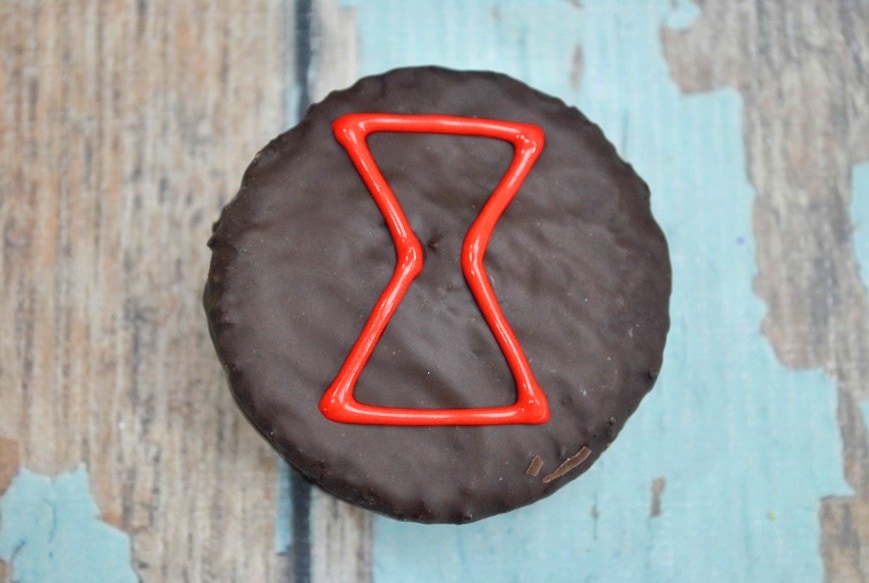 black cookie with hourglass shape in icing