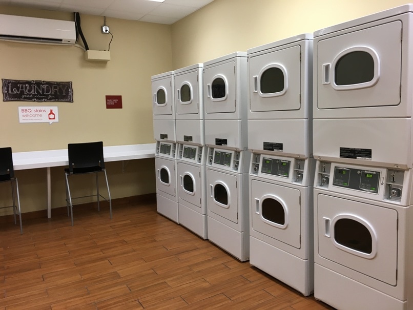 rows of washers and dryers in laundry room