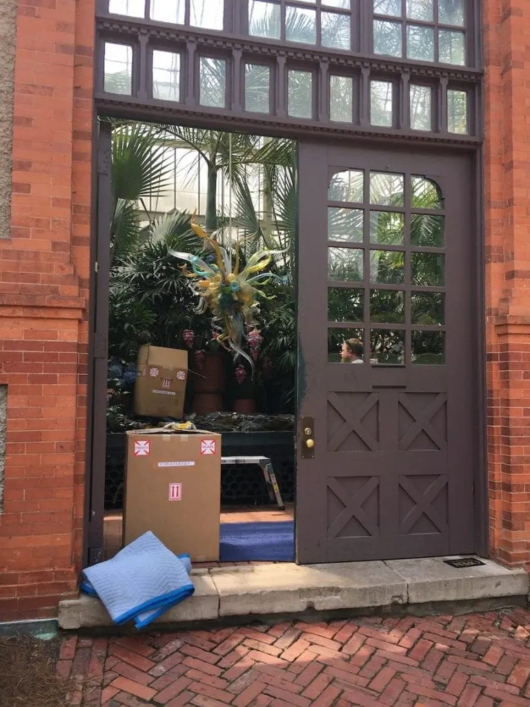 boxes of Chihuly glass pieces in doorway of Biltmore estate conservatory