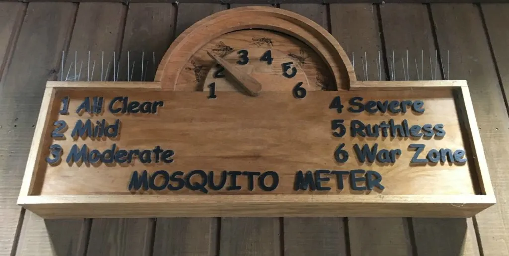 Wooden Mosquito Meter sign measuring how many mosquitoes