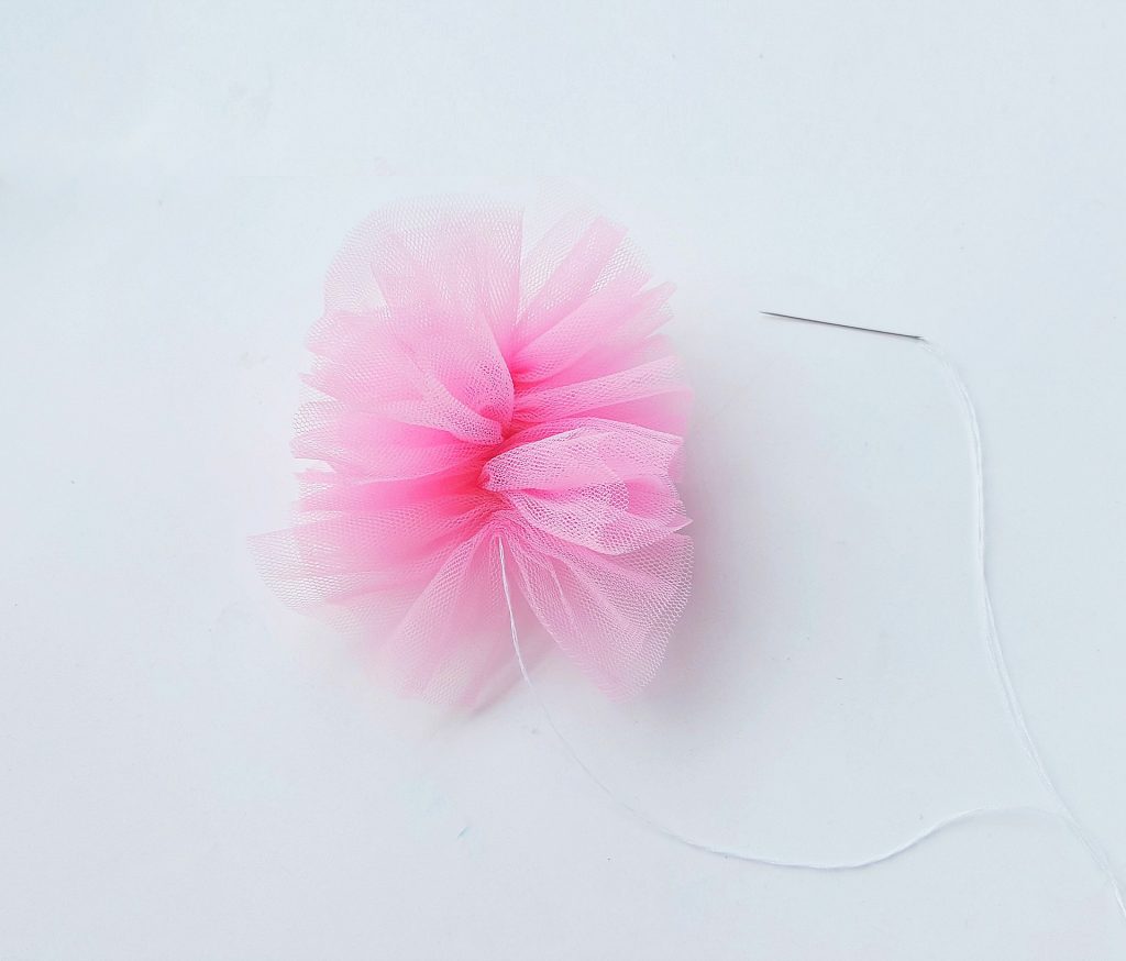 pink shower pouf bath sponge needle and thread