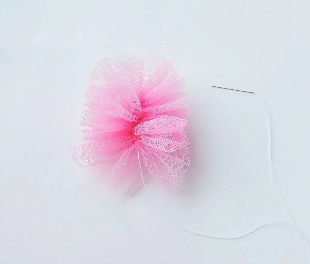 pink shower pouf bath sponge needle and thread