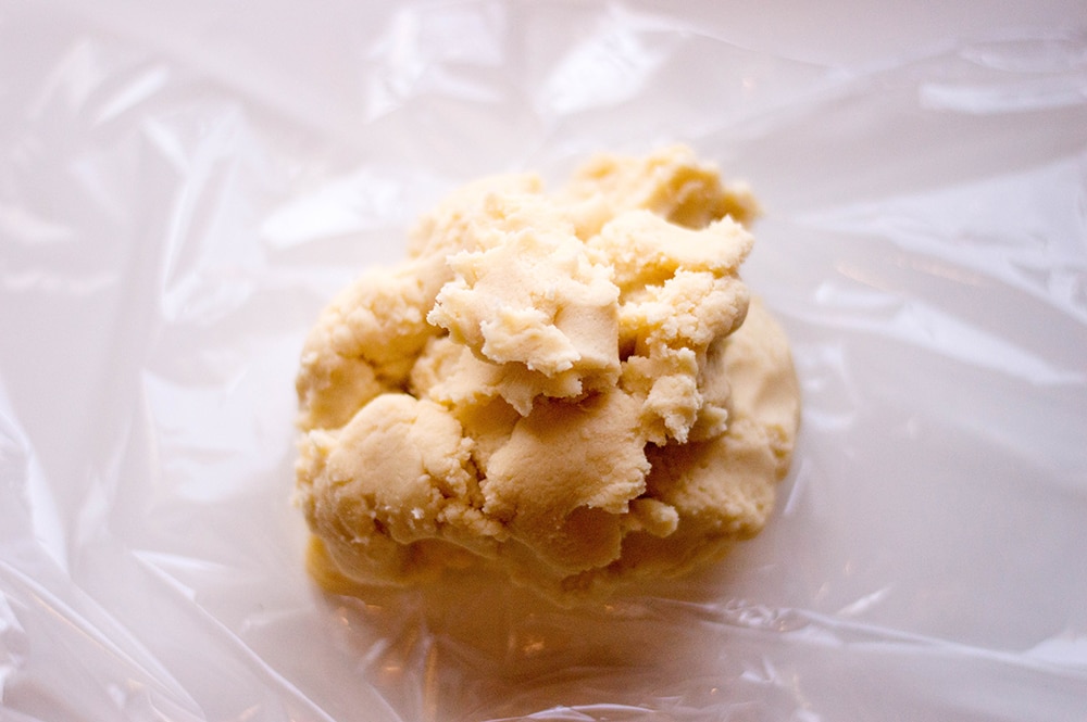 ball of cookie dough on plastic wrap