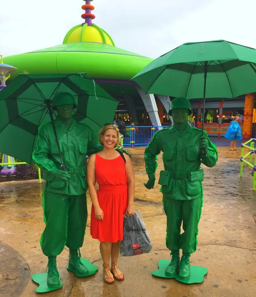 green army men characters with woman in red dress holding umbrellas in the rain at Toy Story Land at Disney's Hollywood Studios