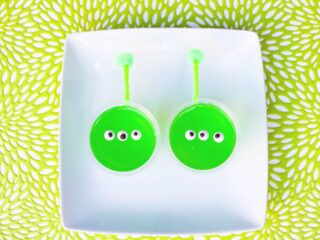 green jello Toy Story alien snack cups with candy eyes and pipe cleaner antennas