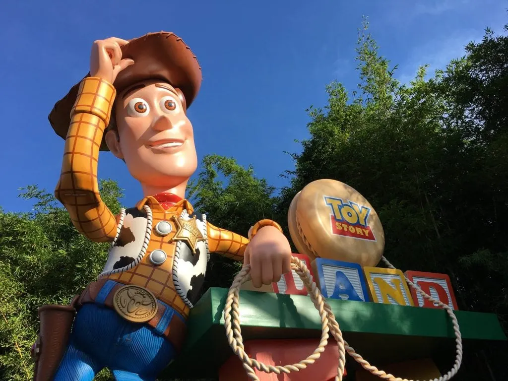 woody at toy story land entrance sign