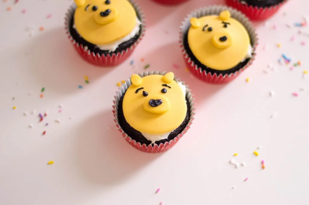 cupcakes with yellow Winnie the pooh faces