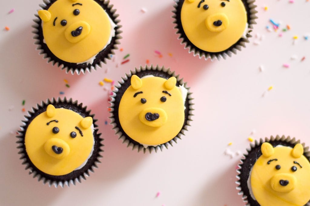 cupcakes with yellow Winnie the pooh faces