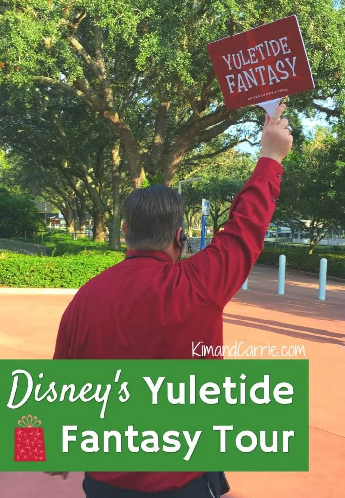man holding up yuletide fantasy tour sign