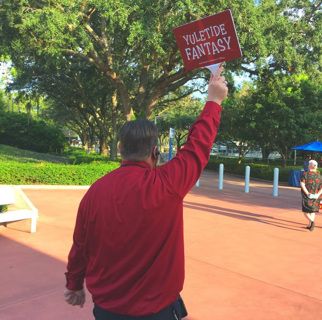 man holding a yuletide fantasy tour sign