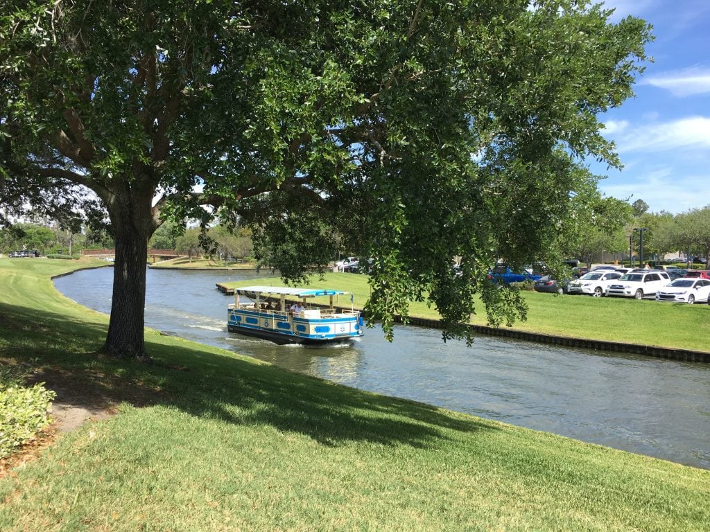 Disney boat transportation in canal heading to Saratoga springs resort