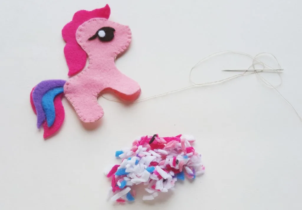 DIY My Little Pony Felt pieces sewn together with a pile of tiny felt scraps to use as stuffing