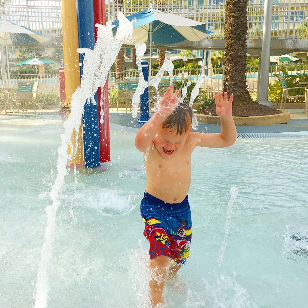 boy running in water play area at Universal Studios Cabana Bay hotel
