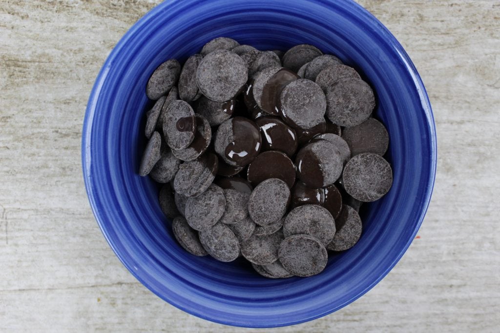 Melted chocolate candy melts in blue bowl