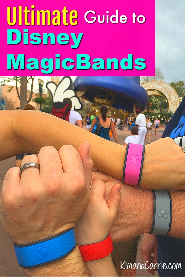 family wearing Disney MagicBands in many colors in front of Sorcer Mickey Hat