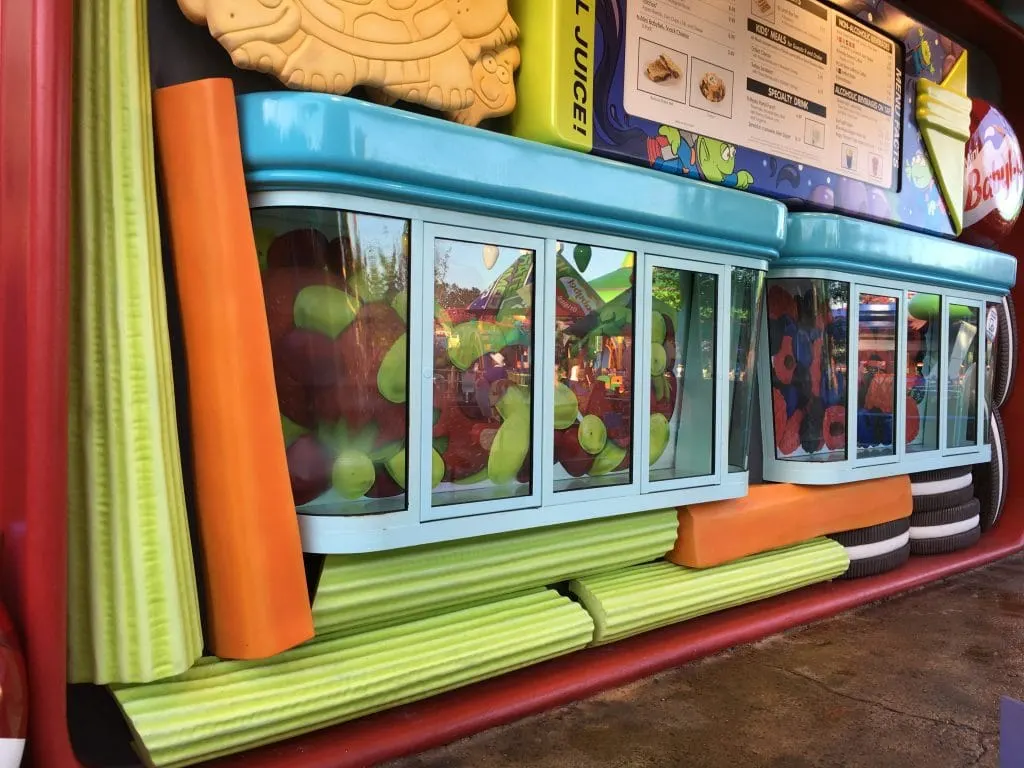 large celery and carrot sticks underneath pick up windows at Disney Toy Story Land Quick Service Restaurant