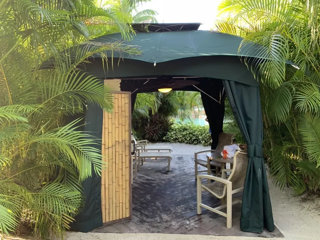 cabana surrounded by palm trees in the sand at Discovery Cove Orlando Florida