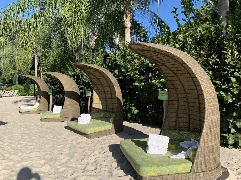 Lounge chairs with shade on the beach at Discovery Cove Orlando Florida