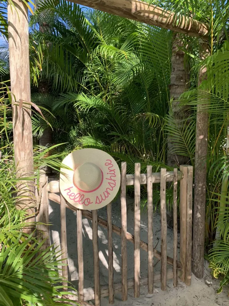 Wooden tropical gate with straw hat hanging at Discovery Cove Orlando Florida