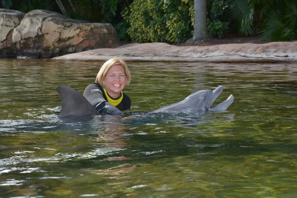 woman hugging dolphin Discovery Cove Orlando Florida