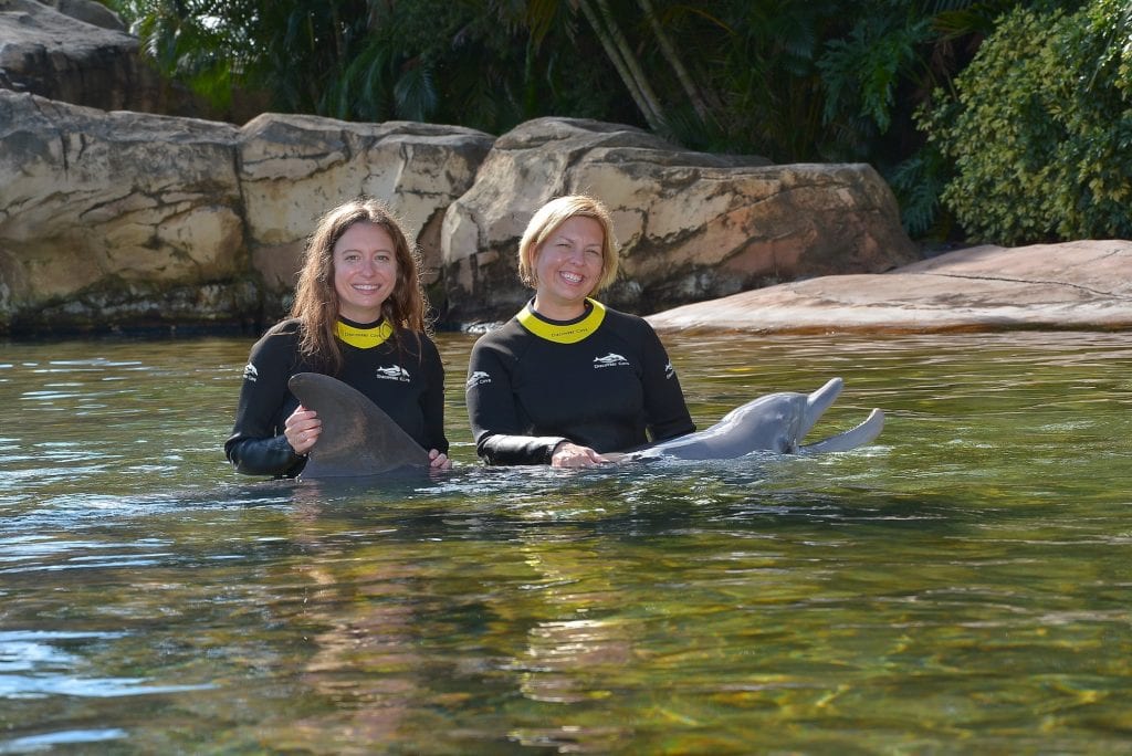two women with dolphin Discovery Cove Orlando Florida