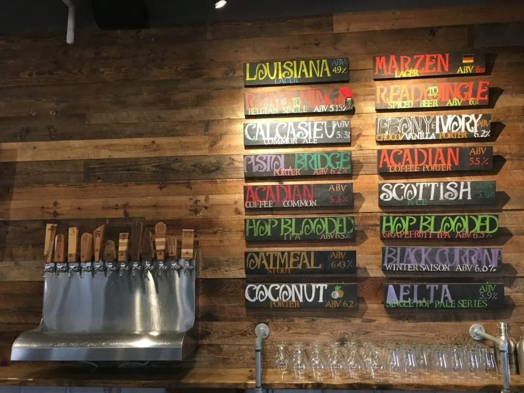 craft beers on tap wooden signs with beer names on wooden wall Lake Charles Louisiana