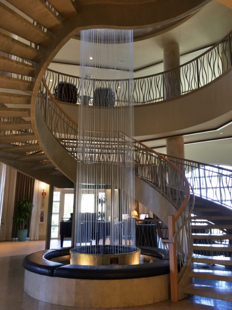 spiral staircase with vertical water feature in Westin cape coral lobby