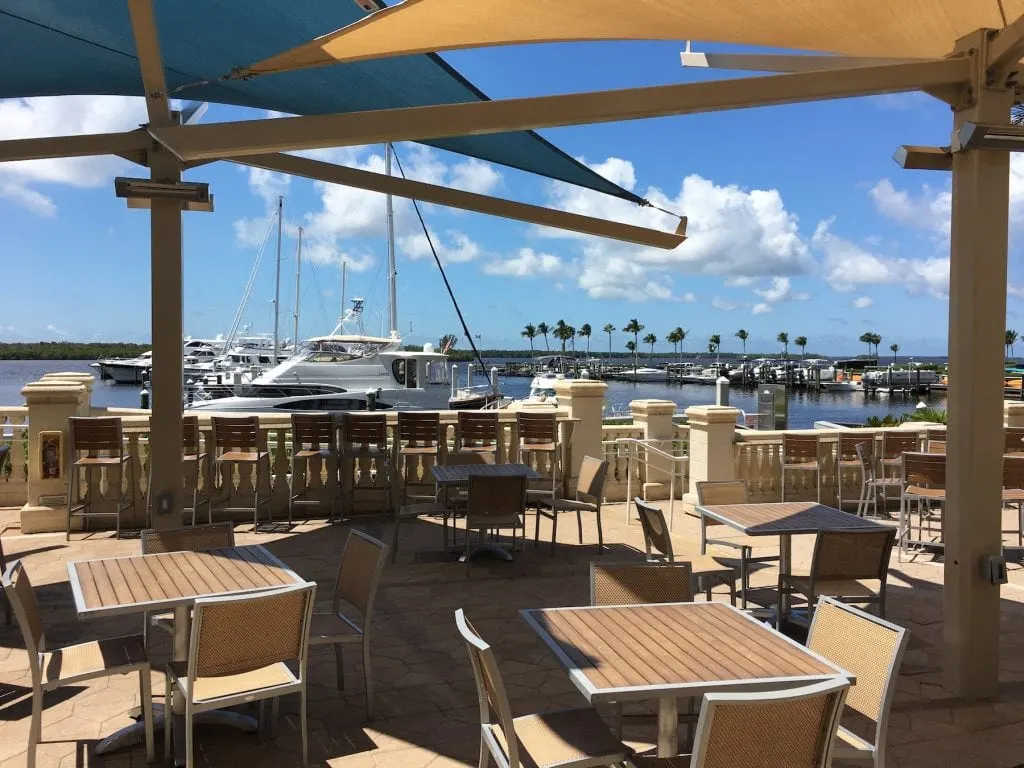 outdoor restaurant seating by water in marina