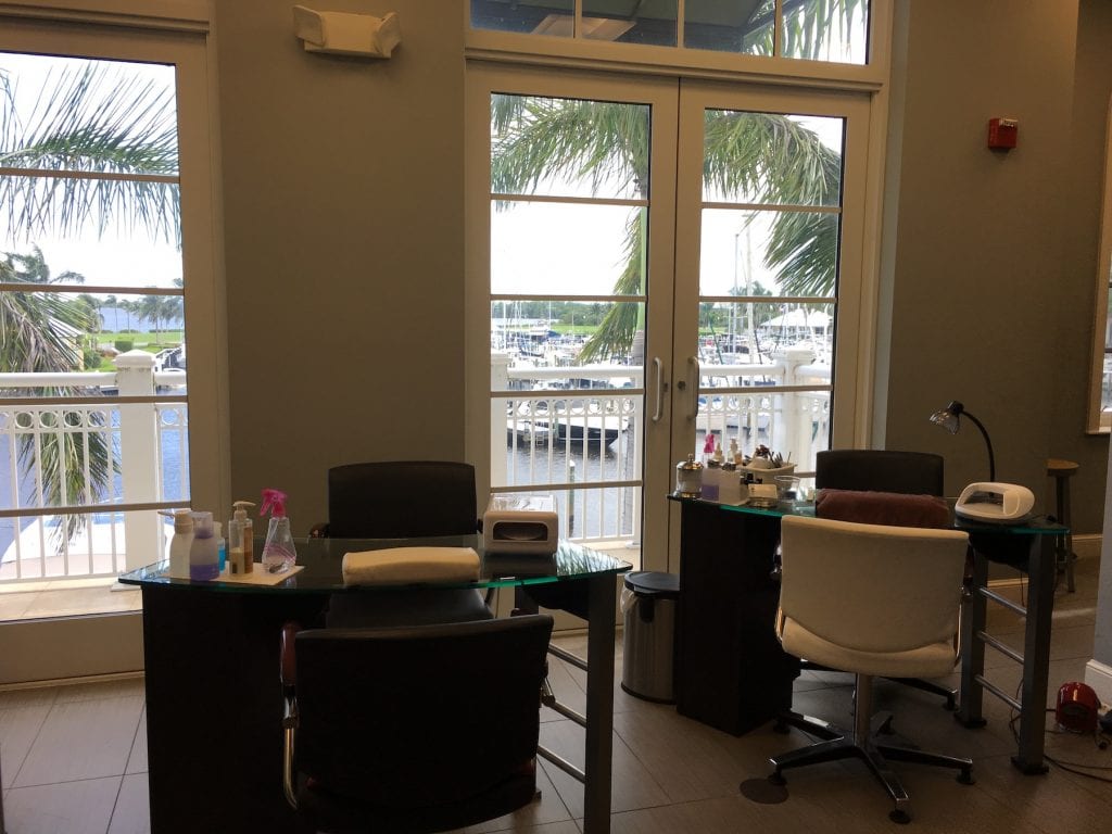 nail salon desks with large windows behind overlooking marina Westin