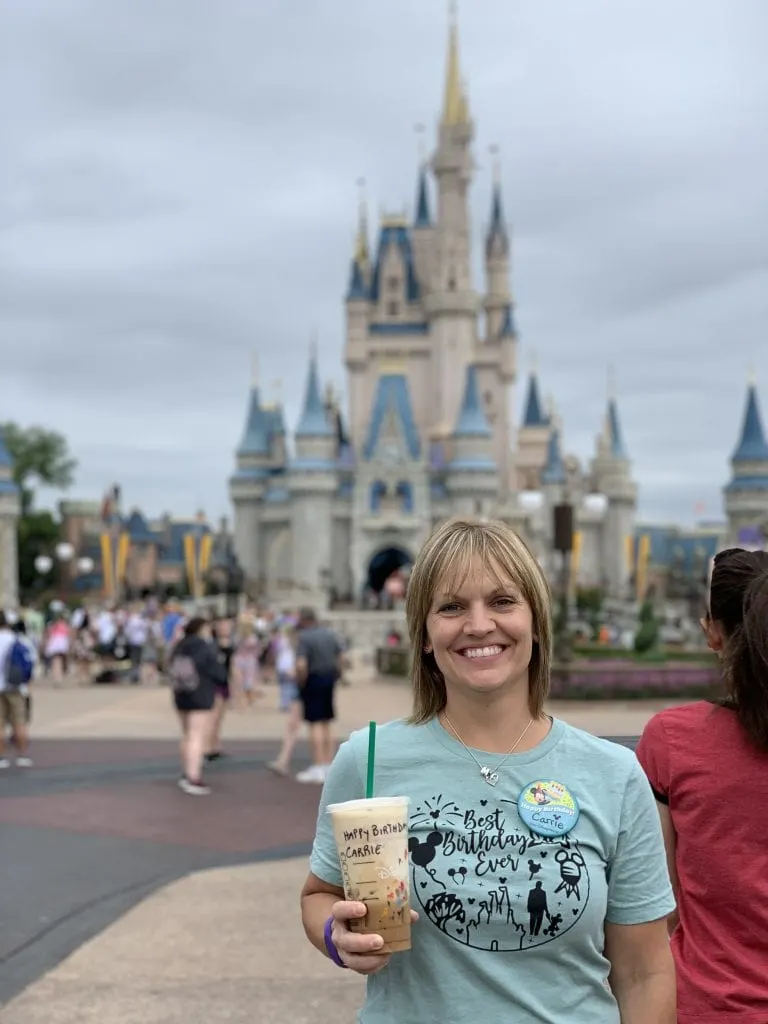 girl celebrating birthday at magic kingdom in front of castle