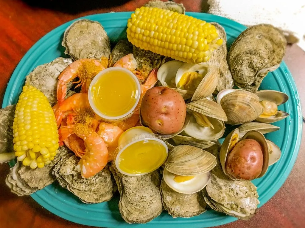 oysters potatoes corn on the cob melted butter on turquoise plate peace river seafood Punta Gorda fl