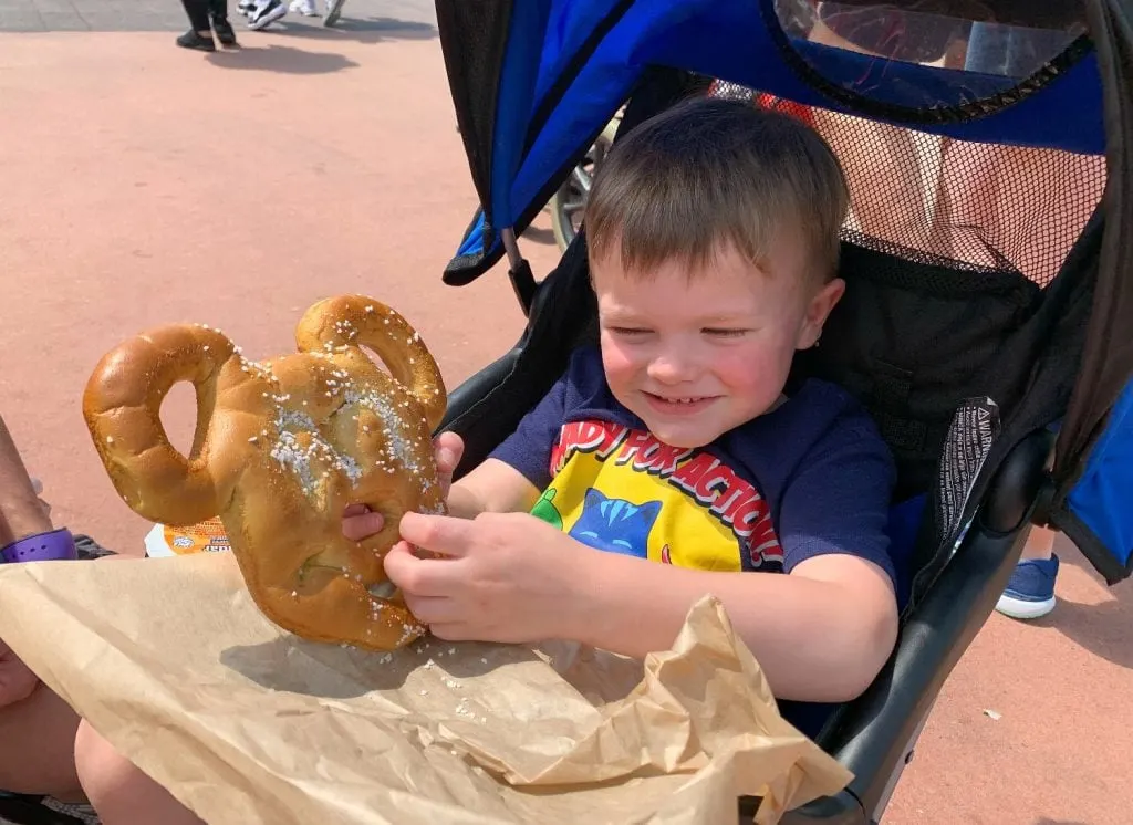 toddler with Mickey Mouse pretzel Walt Disney World