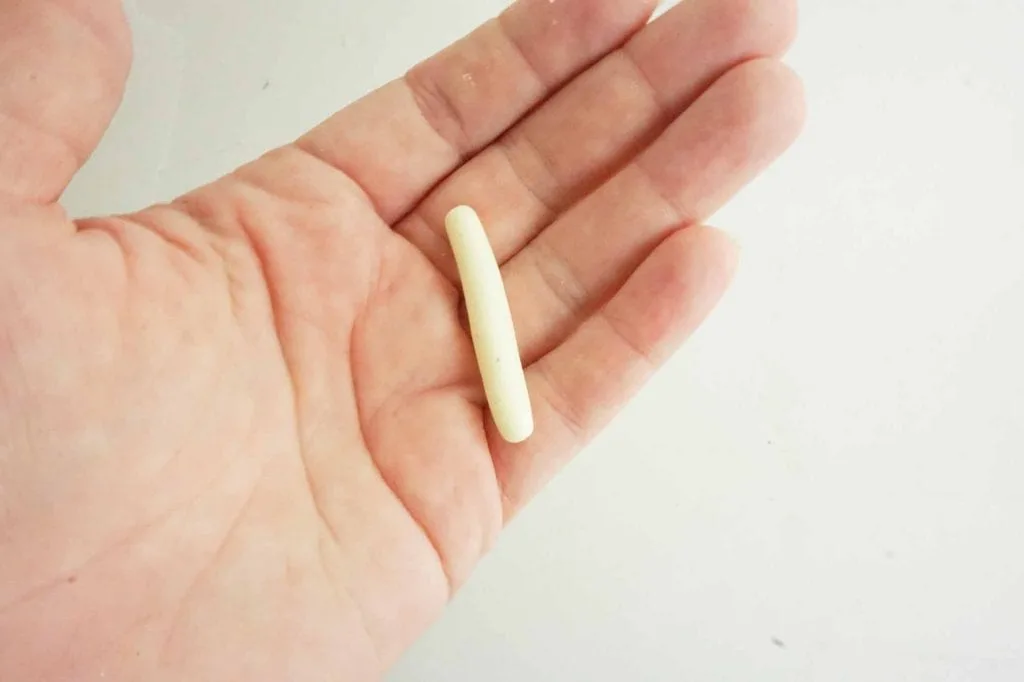 white clay rolled in tube in woman's hand