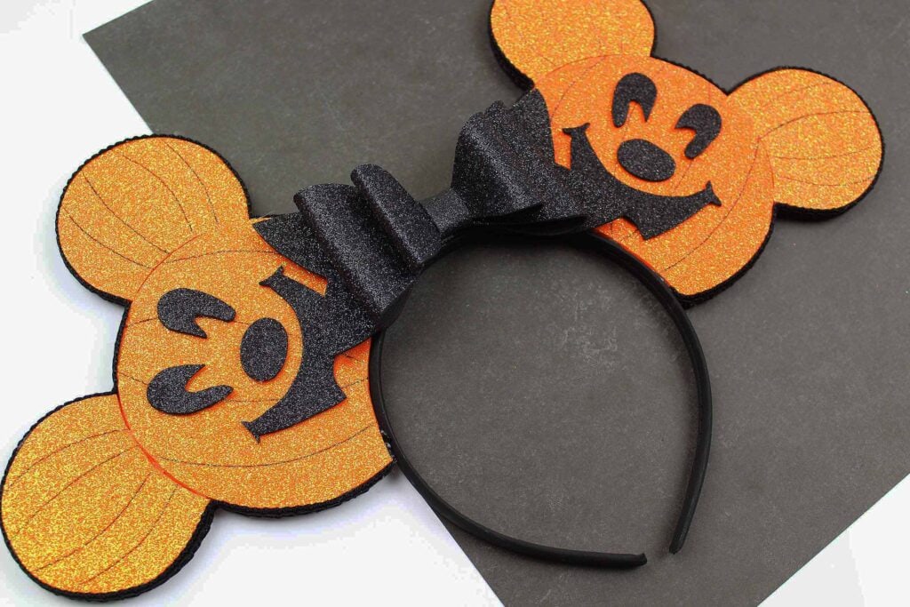 Halloween pumpkin Mickey Ears against black background 