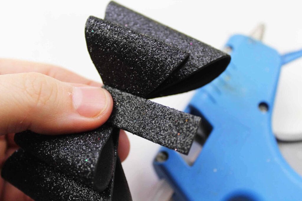 Making a Bow out of black glitter foam for Headband