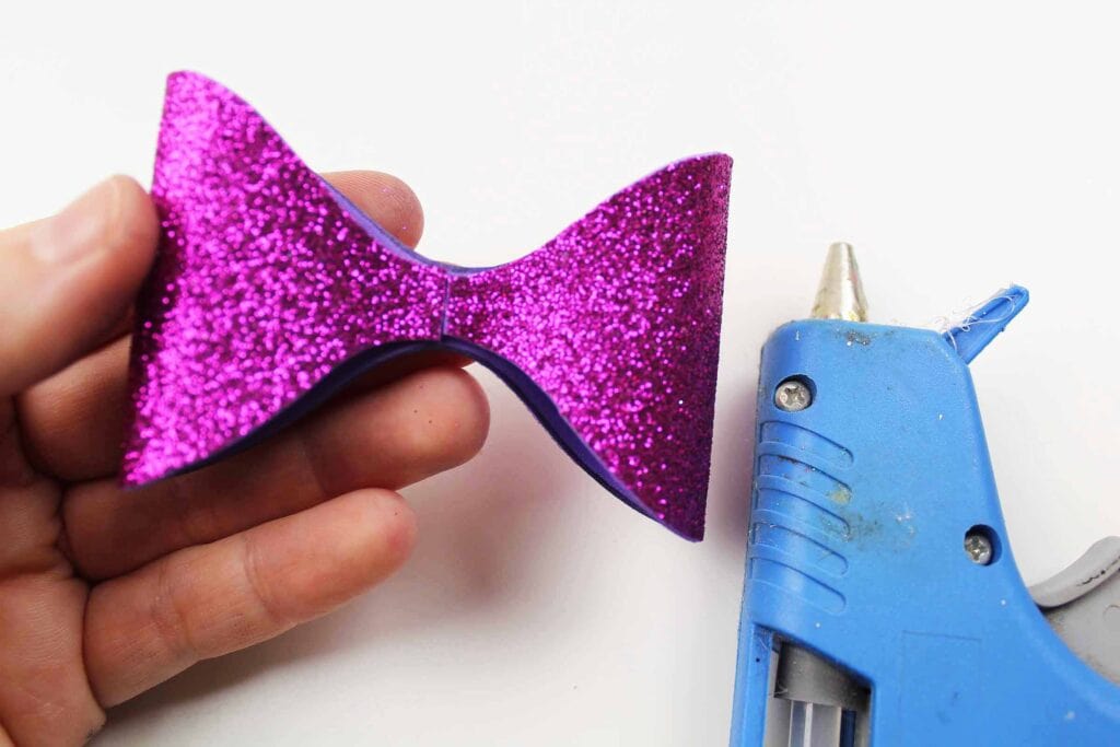 making bow out of purple glitter foam and hot glue