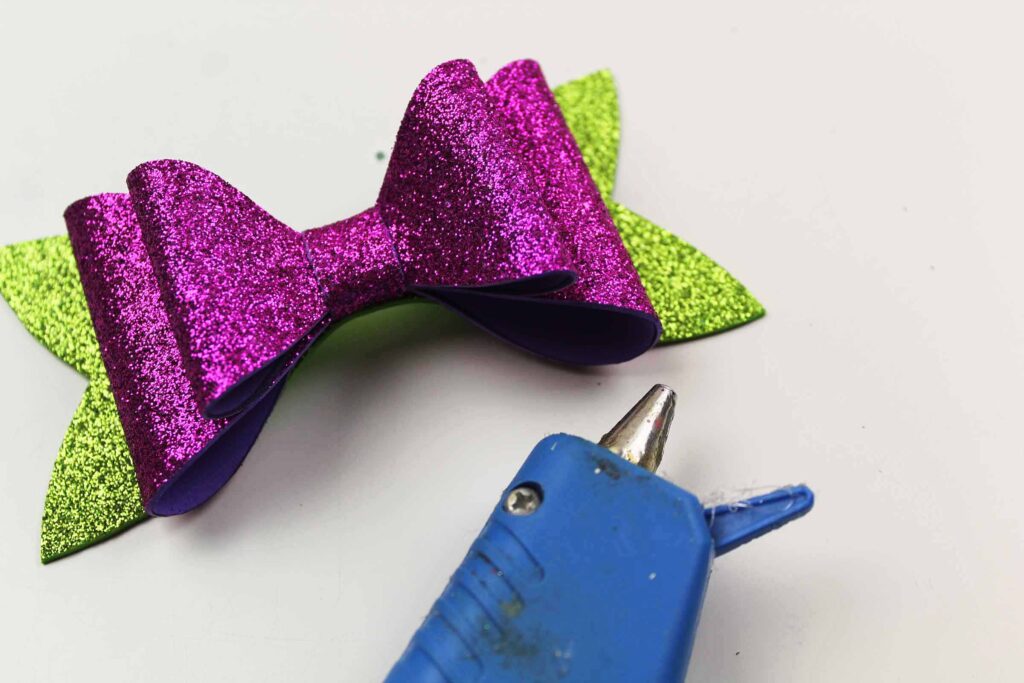 making a purple and green glitter bow