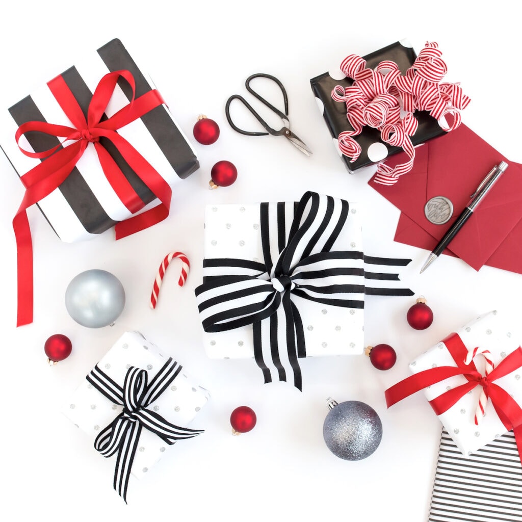 small gift boxes wrapped in black red and white gift wrap for inexpensive stocking stuffers