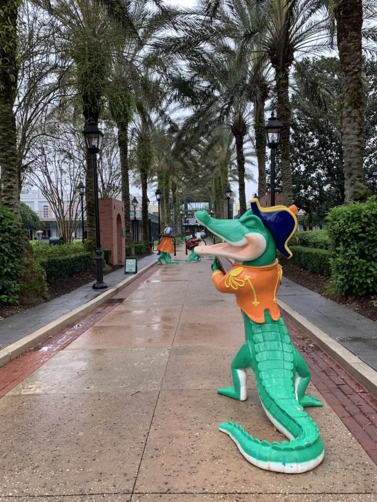 alligator statue in front of palm trees Disney Port Orleans Resort