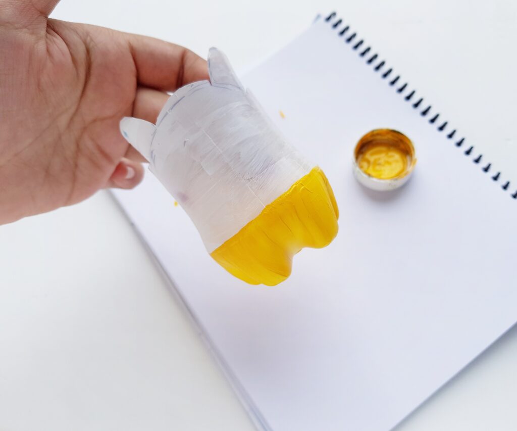 yellow paint on plastic water bottle