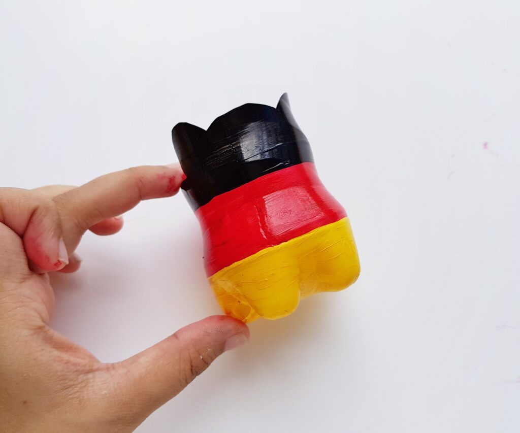 plastic bottle painted in black red and yellow