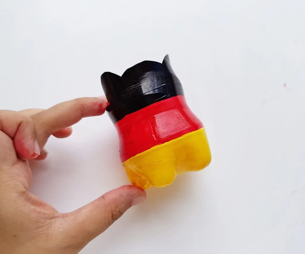 plastic bottle painted in black red and yellow