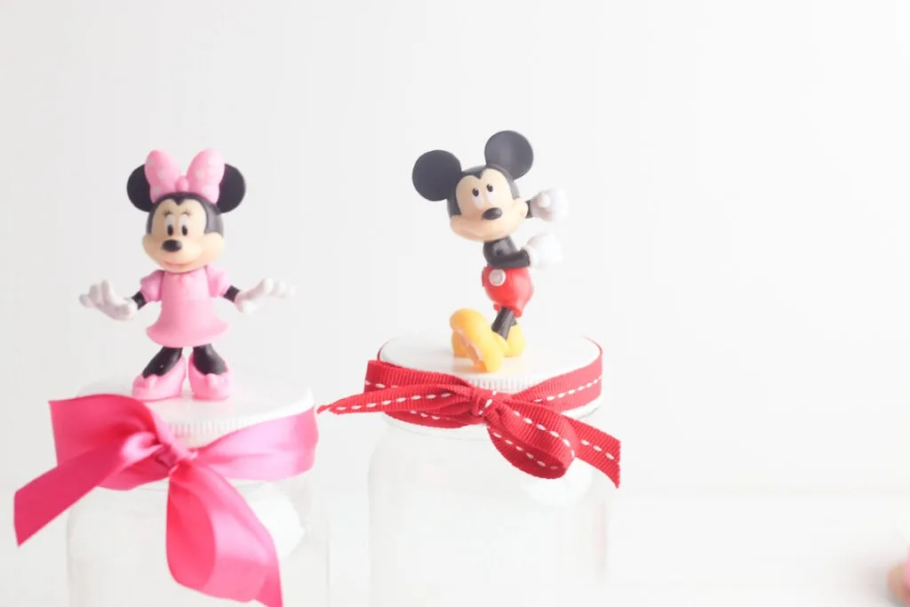 Mickey and Minnie Mouse figurines on storage jars